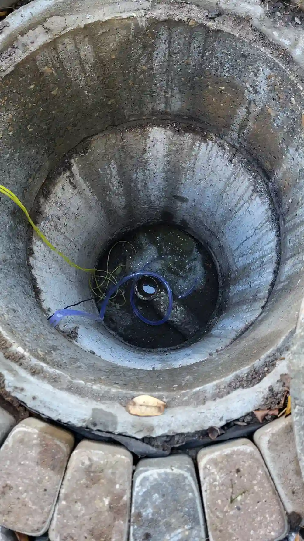 Interior of aging concrete septic tank showing structural wear